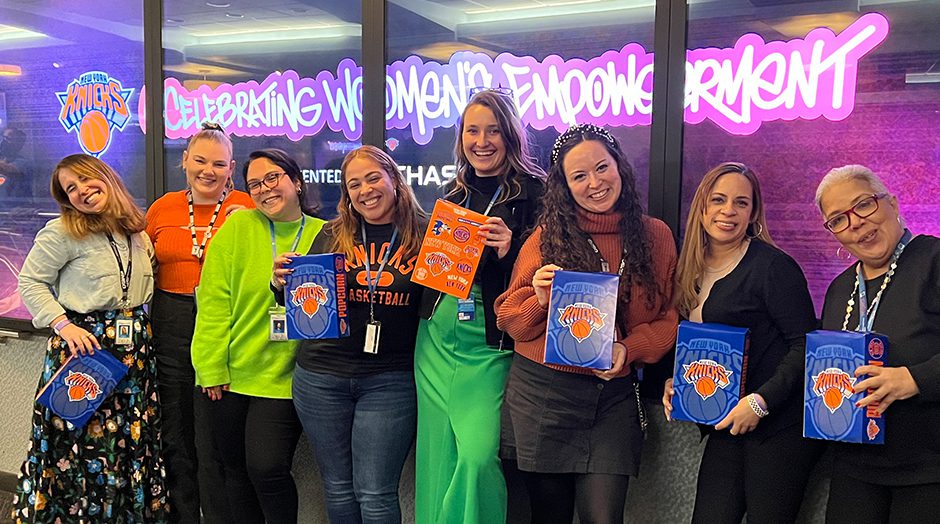 Madison Square Garden Entertainment employees posing for photo with New York Knicks memorabilia