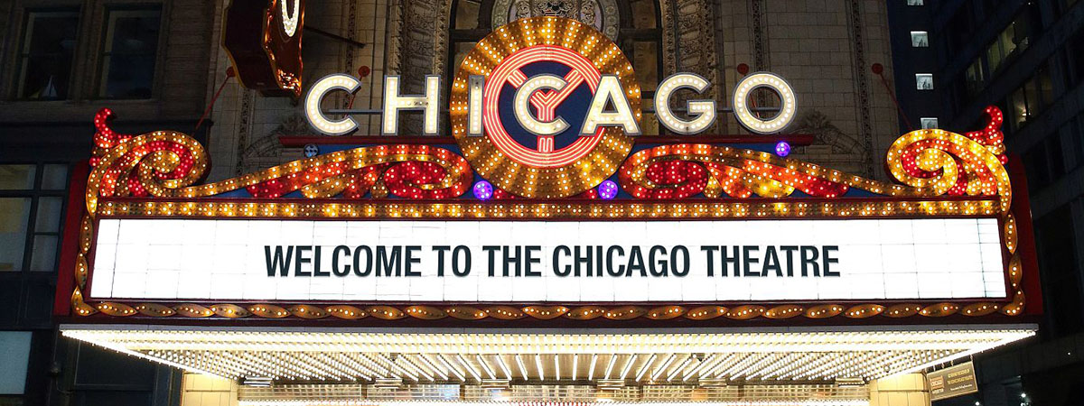 Exterior view of entertainment venue The Chicago Theatre, with a welcome message on the entrance sign